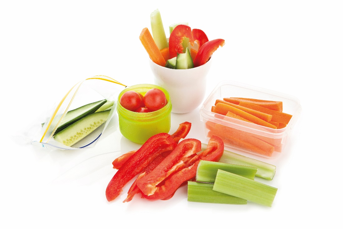 Carrots, celery, cucumber and cherry tomatoes cut up in different ways and in various containers