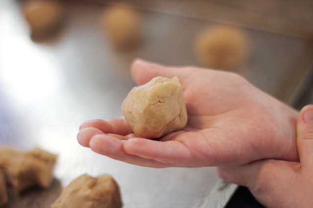 Child's hand rolling dough