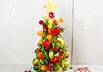 A Christmas tree made out of fruit