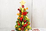 A Christmas tree made out of fruit