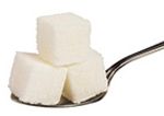 A teaspoon holding 3 sugar cubes