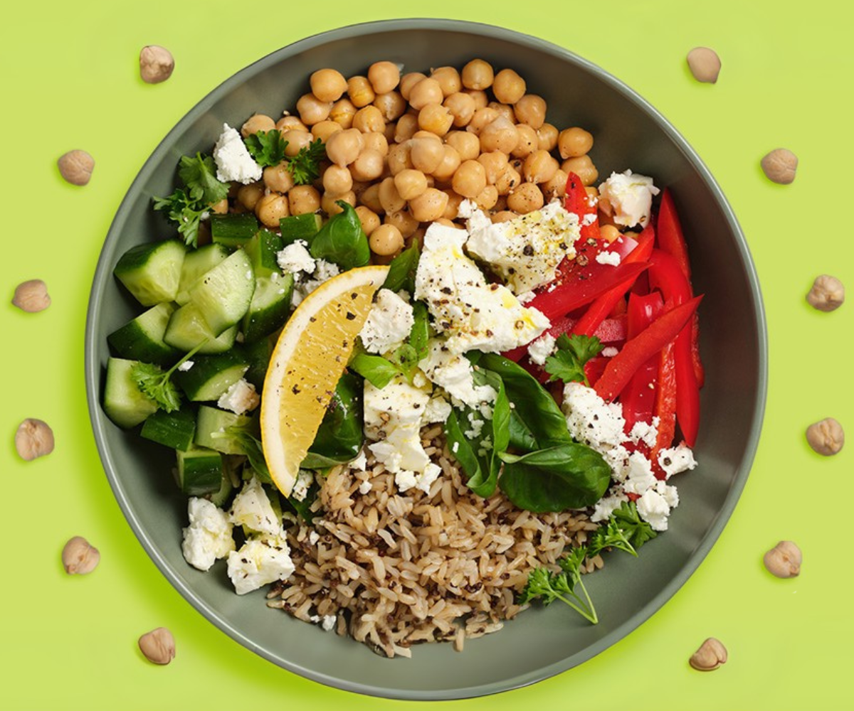 Salad bowl with chickpeas, capsicum, cucumber, rice, fetta, lemon
