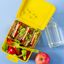 yellow lunchbox with sandwich fruit and vegetables