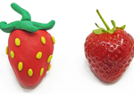 Close ups of a strawberry made of playdough and a real strawberry