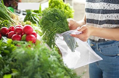 Close up of a woman bagging some greens