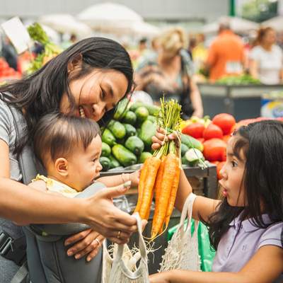 woman grocery shopping with children