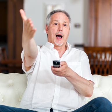 man shouting at the tv