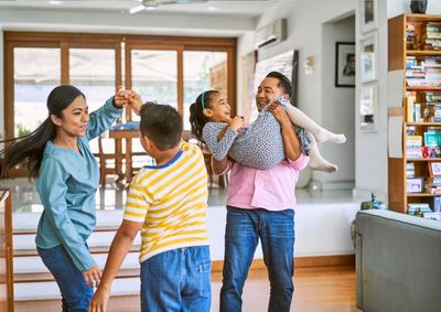 Family dancing in the living room