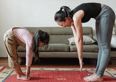 Mum and daughter stretching 