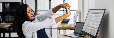 woman doing wrist stretches at her desk