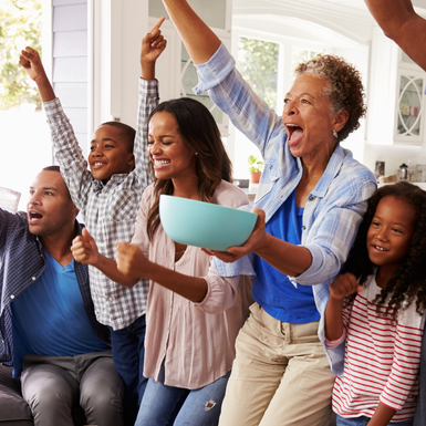 family with raised arms cheering