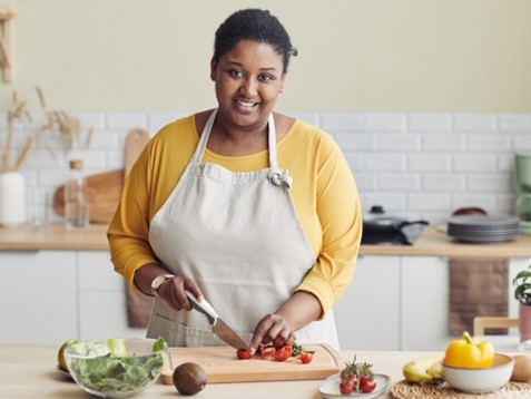 A person prepares a salad at home