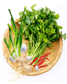 cooked bok choy and choy sum on a plate with sesame seeds 