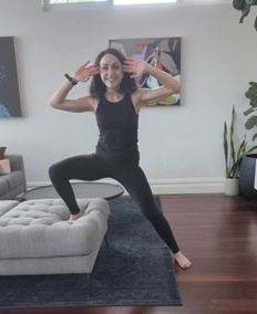 Tania is smiling in finishing position for side lunges