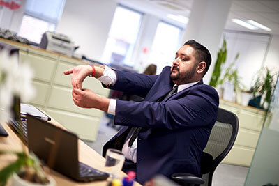 Man stretching at desk