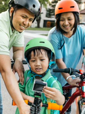 Family walking, riding and scooting together