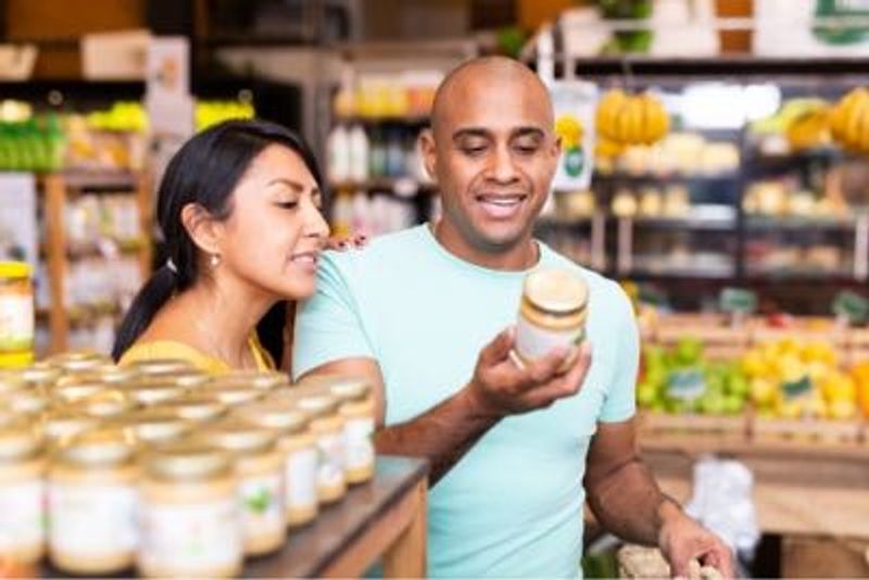 two people shopping and reading food labels