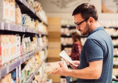 man reading a food label