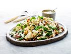 A roasted cauliflower salad, with bright baby spinach leaves, pearl barley and a yoghurt dressing  